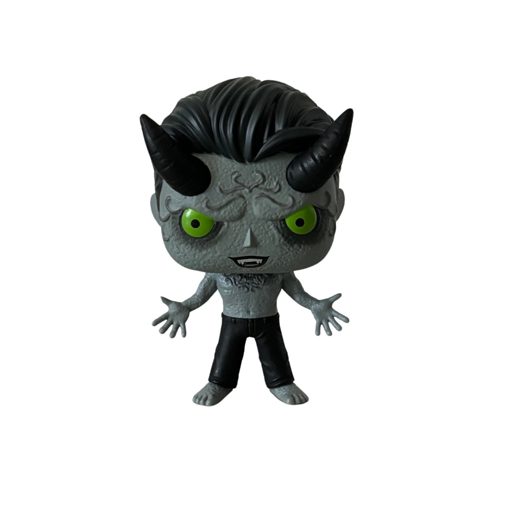 Cartoon-style figurine of a gray, demonic character with green eyes and black horns.