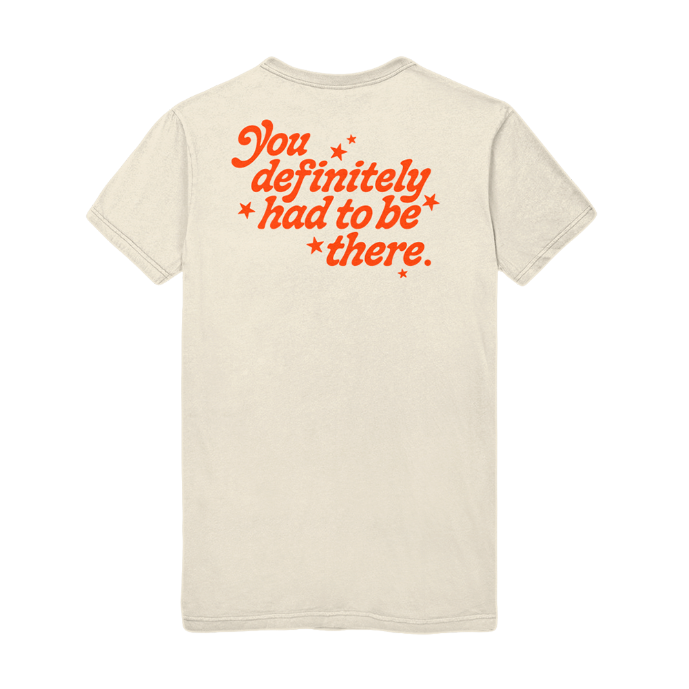 Beige t-shirt with orange text on the back saying ’You definitely had to be there.’