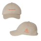 Beige baseball cap with orange text and logo.